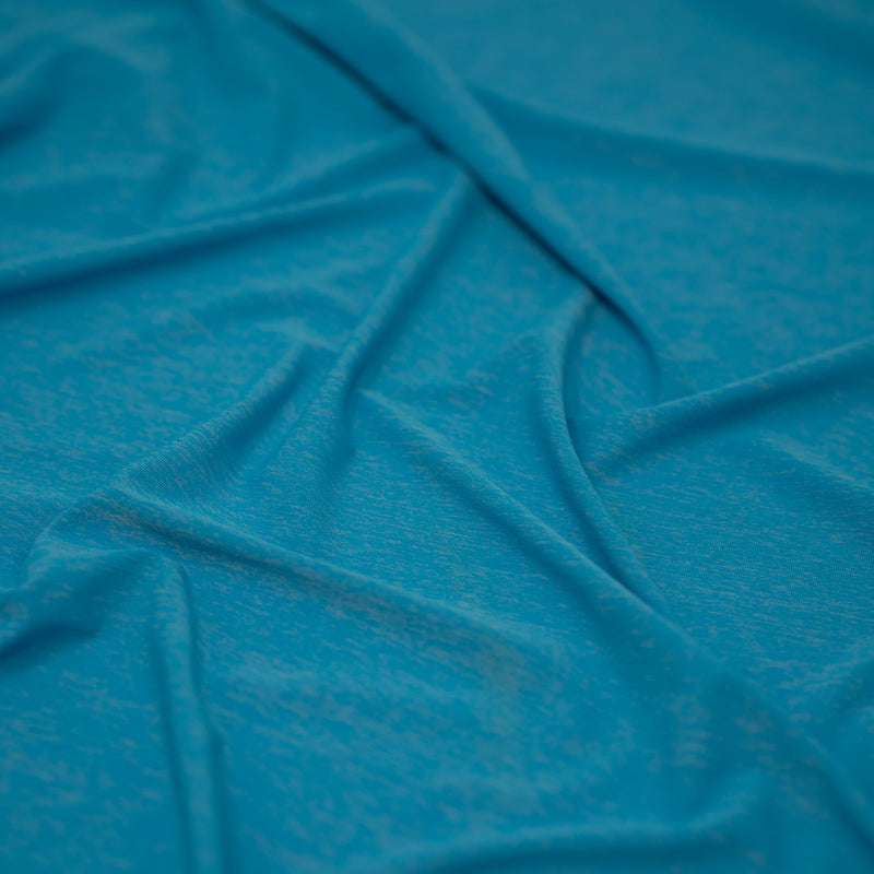 Detailed shot of UniFlex Nylon Polyester Spandex Reversible Knit Top Weight Fabric in color Diva Blue. 