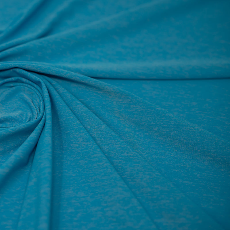 Detailed shot of swirled UniFlex Nylon Polyester Spandex Reversible Knit Top Weight Fabric in color Diva Blue. 