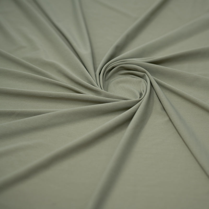 Detailed shot of swirled UniFlex Nylon Polyester Spandex Reversible Knit Top Weight Fabric in color Khaki Green.. 