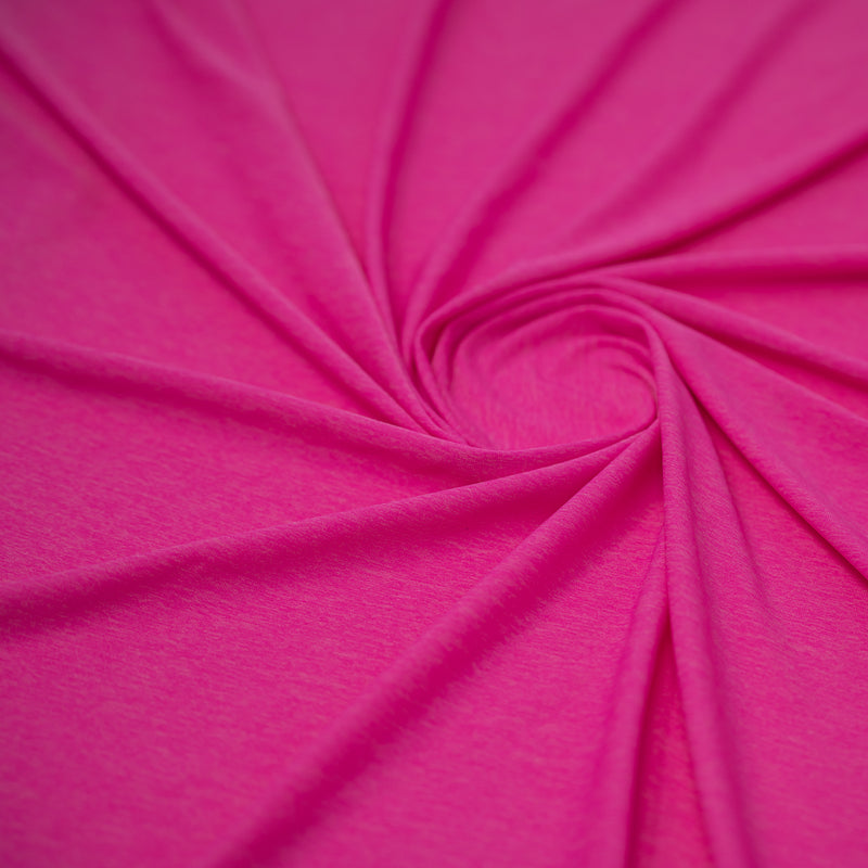 Detailed shot of swirled UniFlex Nylon Polyester Spandex Reversible Knit Top Weight Fabric in color Positive Pink. 