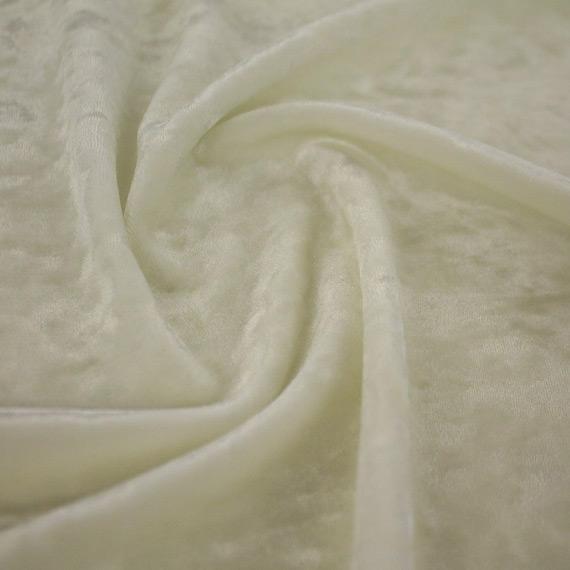A swirled sample of revival crushed stretch velvet in the color ivory.