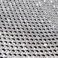 A flat sample of rhinestone aluminum scale mesh in the color clear.