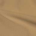 A rippled piece of Ribbed Spandex in the color almond.