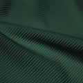 A rippled piece of Ribbed Spandex in the color apline green.