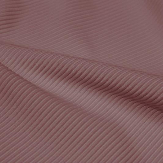 A rippled piece of Ribbed Spandex in the color antique rose.