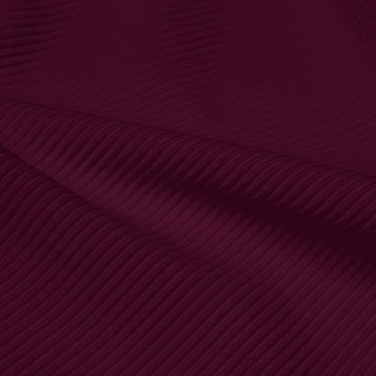 A rippled piece of Ribbed Spandex in the color fig.