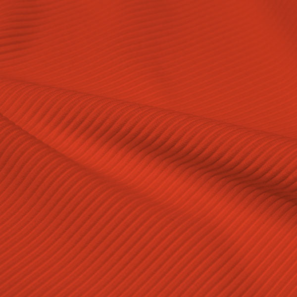 A rippled piece of Ribbed Spandex in the color hot coral.