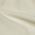 A rippled piece of Ribbed Spandex in the color ivory.
