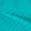A rippled piece of Ribbed Spandex in the color light turquoise.