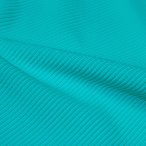 A rippled piece of Ribbed Spandex in the color light turquoise.