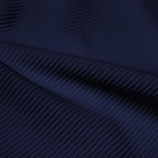 A rippled piece of Ribbed Spandex in the color marine navy.