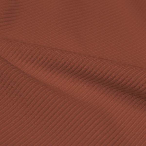 A rippled piece of Ribbed Spandex in the color pale copper.