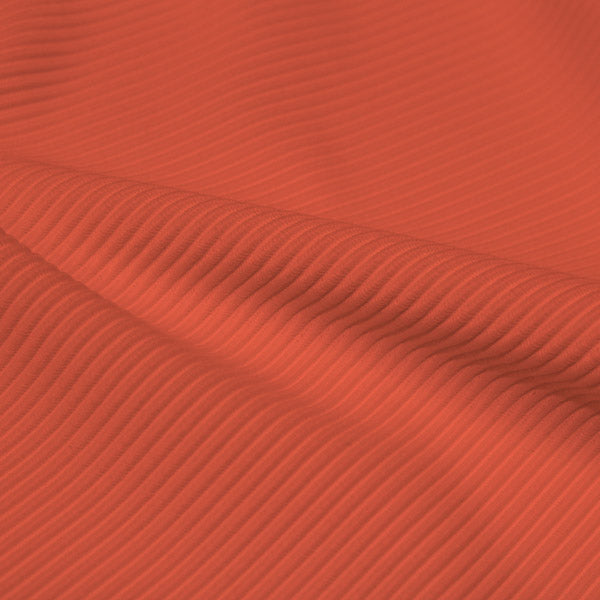A rippled piece of Ribbed Spandex in the color peachberry.