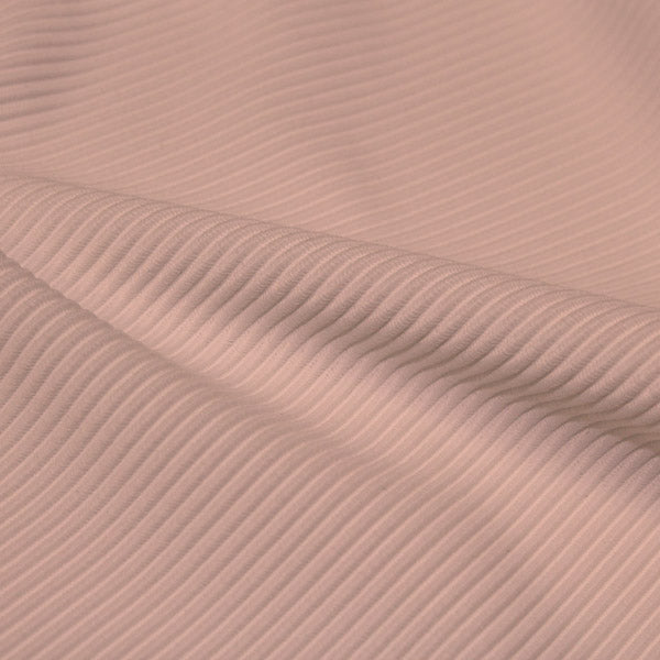 A rippled piece of Ribbed Spandex in the color petal dust.