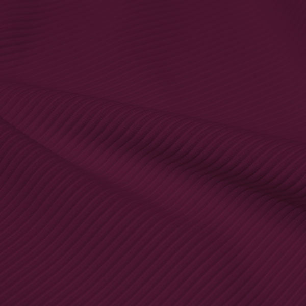 A rippled piece of Ribbed Spandex in the color purple plum.