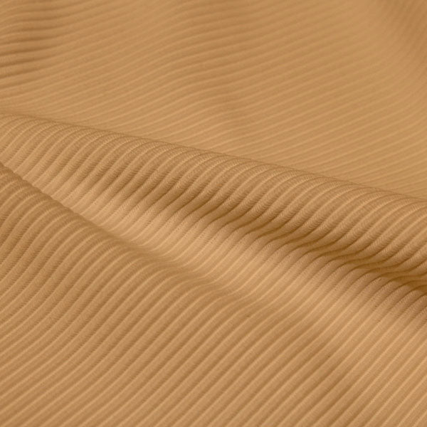 A rippled piece of Ribbed Spandex in the color soft apricot.