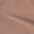 A rippled piece of Ribbed Spandex in the color sun beige.