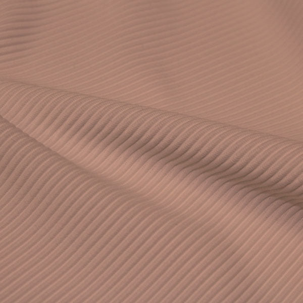 A rippled piece of Ribbed Spandex in the color sun beige.