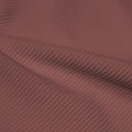 A rippled piece of Ribbed Spandex in the color toast.