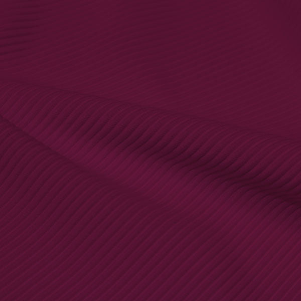 A rippled piece of Ribbed Spandex in the color wine.