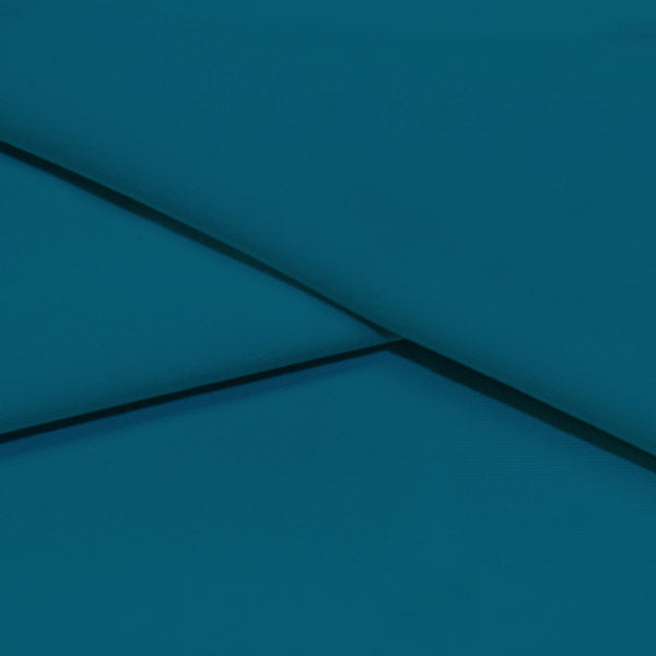 A folded piece of Ripple Recycled Polyester Spandex in the color deep turquoise.
