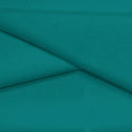 A folded piece of Ripple Recycled Polyester Spandex in the color teal green.