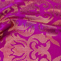 A swirled sample of rome foil printed spandex in the color bright purple-gold.