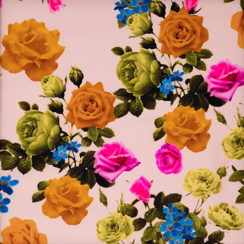 Detailed shot of Rose Garden Printed Spandex Fabric. The print is of fluorescent pink, olive green and burnt orange roses on olive green colored stems with leaves with tiny blue flowers on a cream pink background. 