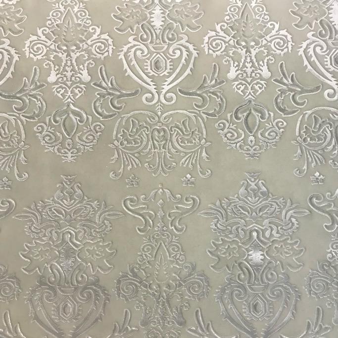 A flat sample of royalty embossed tretch velver in the color cream.