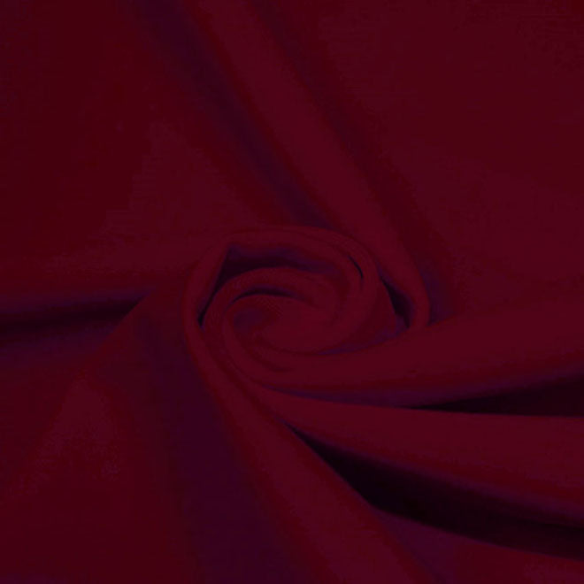 A swirled piece of microfiber nylon spandex in the color EBI Burgundy