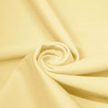 A swirled piece of microfiber nylon spandex in the color Ivory