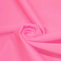 A swirled piece of microfiber nylon spandex in the color Pink Sorbet