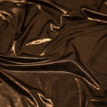 A swirled sample of sheen foiled spandex in the color Dark-Chocolate-Light-Bronze