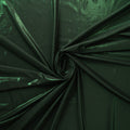 A swirled foiled spandex in the color pine dark green.