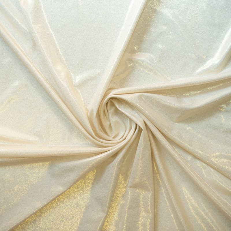 A swirled sample of sheen foiled spandex in the color white-gold.