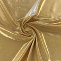 A swirled piece of sheen foiled spandex in the color gold.