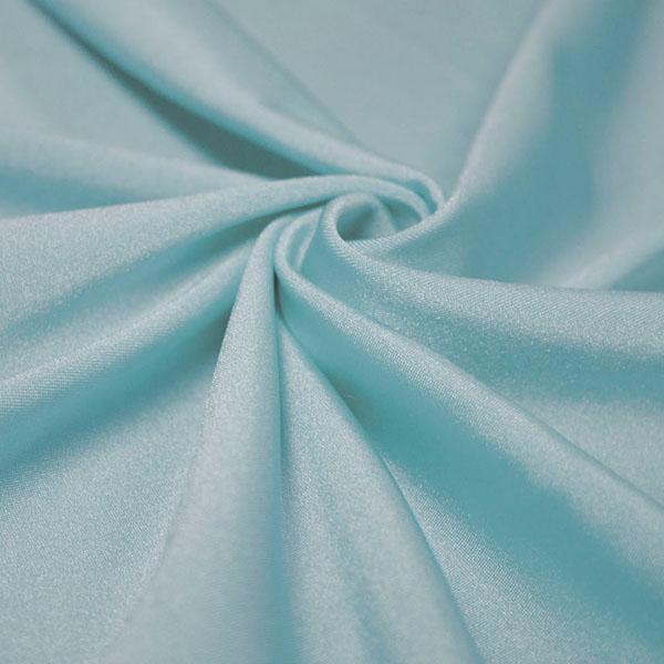 A swirled piece of shiny nylon spandex in the color baby blue.