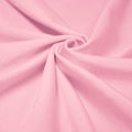 A swirled piece of shiny nylon spandex in the color baby pink.