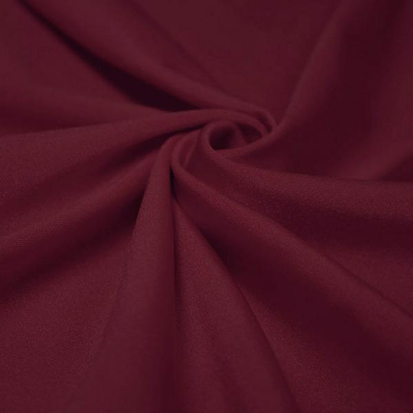 A swirled piece of shiny nylon spandex in the color burgundy.