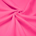 A swirled piece of shiny nylon spandex in the color crimson pink.