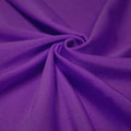 A swirled piece of shiny nylon spandex in the color deep purple.