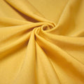 A swirled piece of shiny nylon spandex in the color gold.