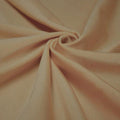 A swirled piece of shiny nylon spandex in the color latte.