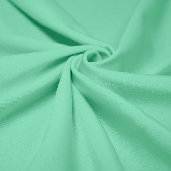 A swirled piece of shiny nylon spandex in the color menthol.