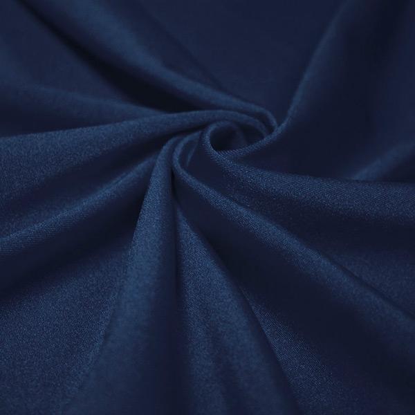 A swirled piece of shiny nylon spandex in the color navy.