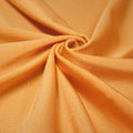 A swirled piece of shiny nylon spandex in the color nutmeg.