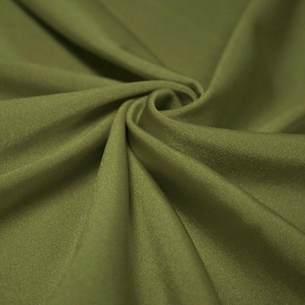 A swirled piece of shiny nylon spandex in the color olive.