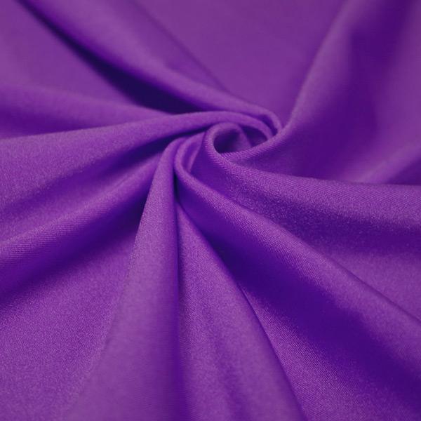 A swirled piece of shiny nylon spandex in the color purple.
