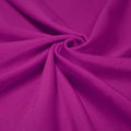 A swirled piece of shiny nylon spandex in the color rosebud.