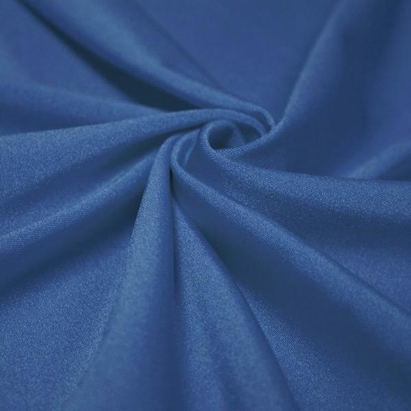 A swirled piece of shiny nylon spandex in the color royal.